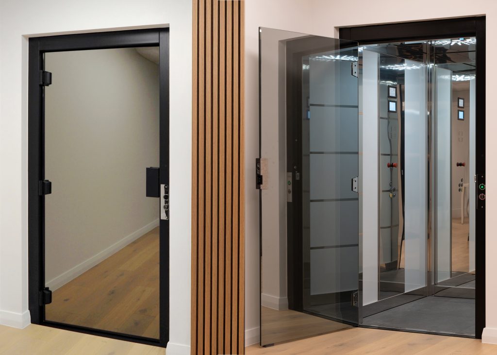 A split image showing two modern lift entrances. On the left, a door with a black frame standing open, leading to a simple hallway with light wooden flooring. On the right, an open lift with glass-panelled doors, revealing a bright interior with mirrored surfaces and control buttons. A wooden accent wall divides the two sections. The settings are sleek and contemporary, with a focus on clean lines and minimalist design.