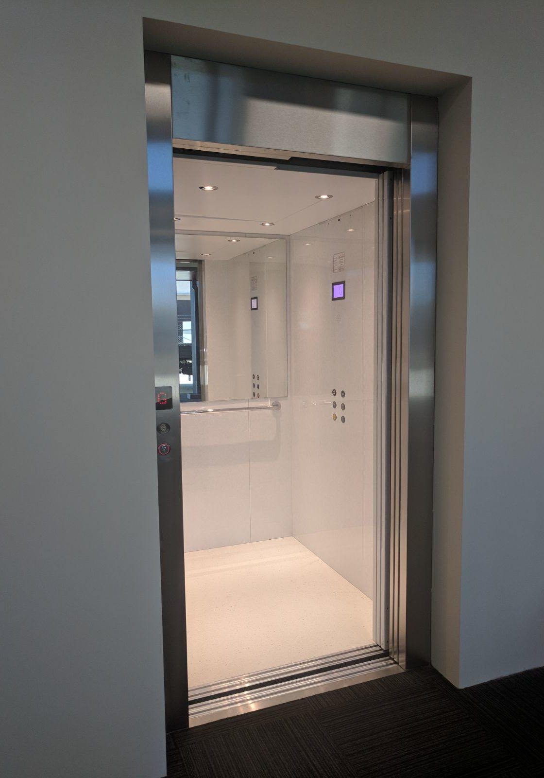 Open doors of a stylish and luxurious commercial suite lift